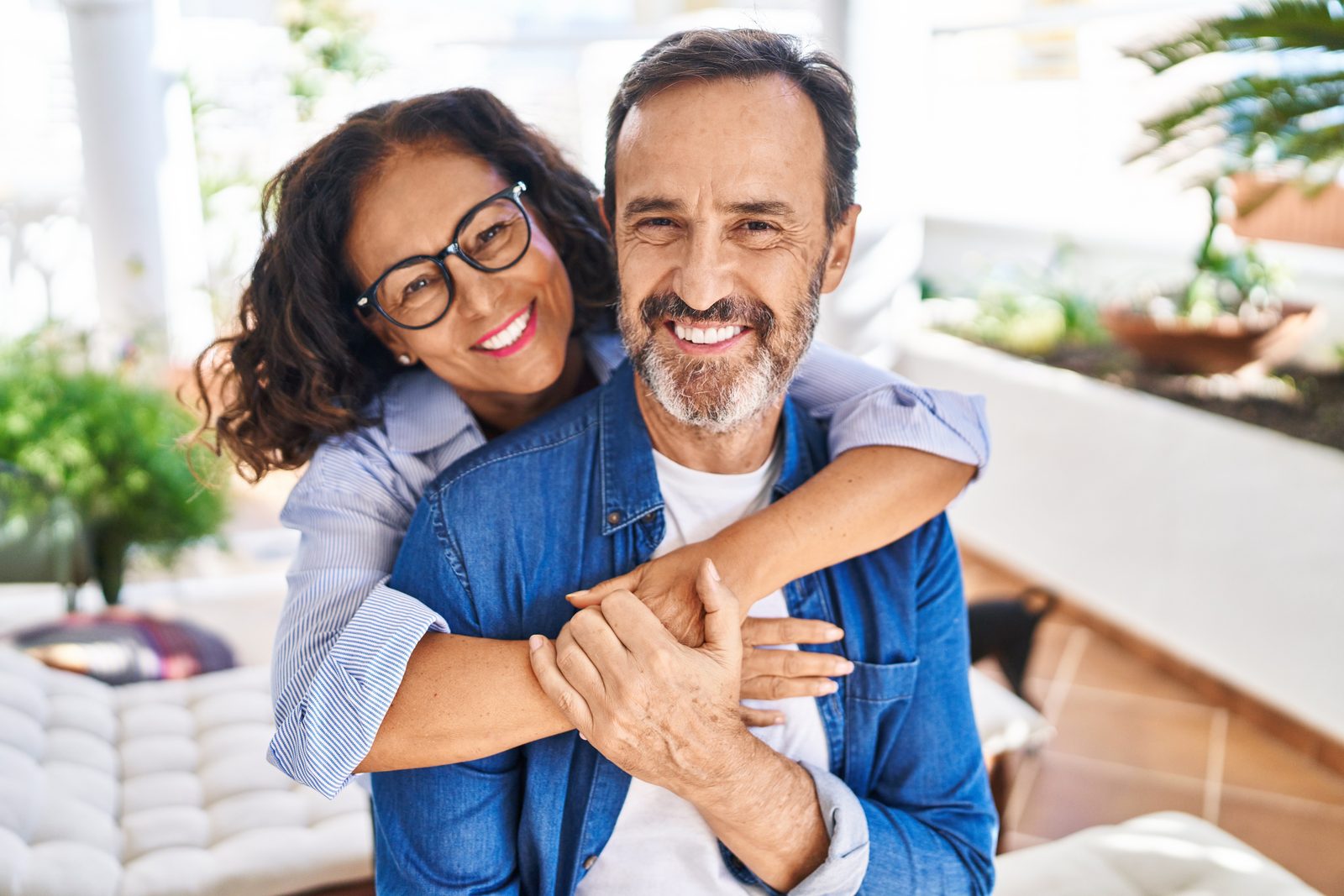 A happy mature couple embracing at home